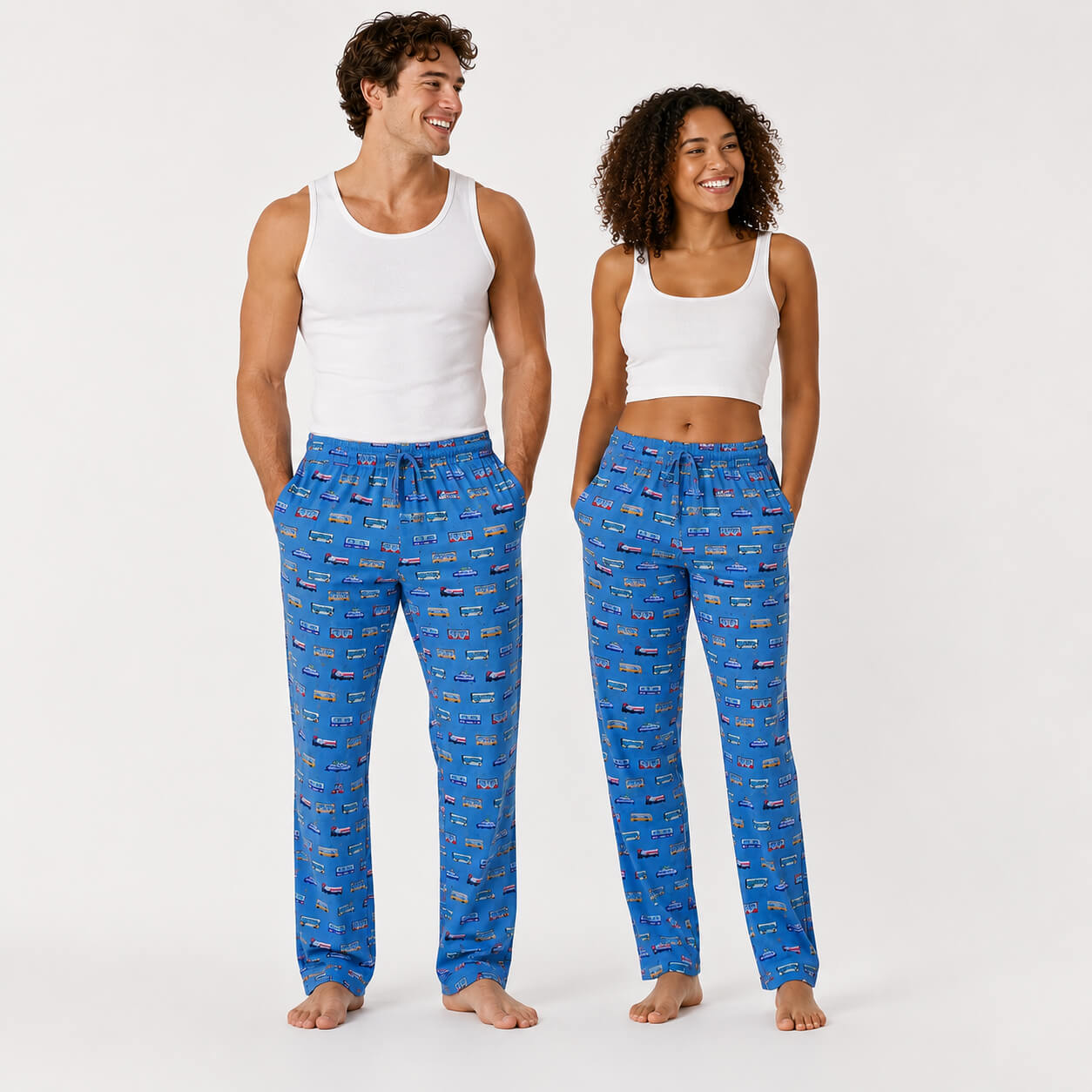 Young man and woman wearing blue pajama pants with a pattern of Boston MBTA transit vehicles