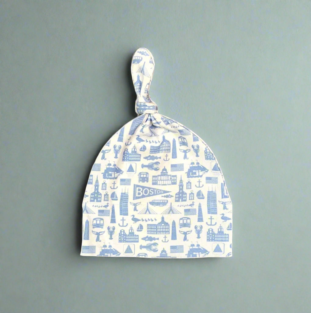 white knit newborn baby hat with blue Boston Massachusetts landmark pattern