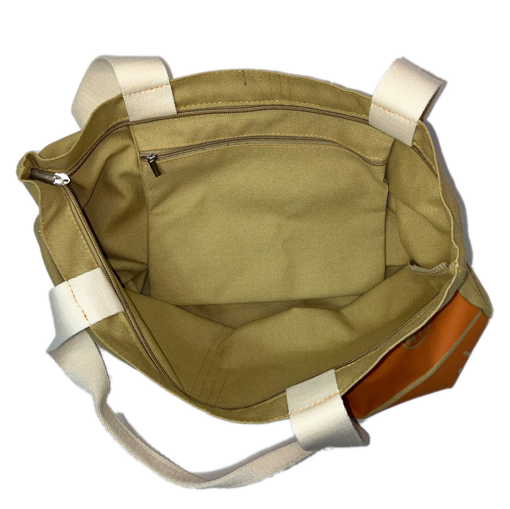 Tan canvas tote bag with large orange Boston MBTA PCC bus graphic and inner zipper pocket