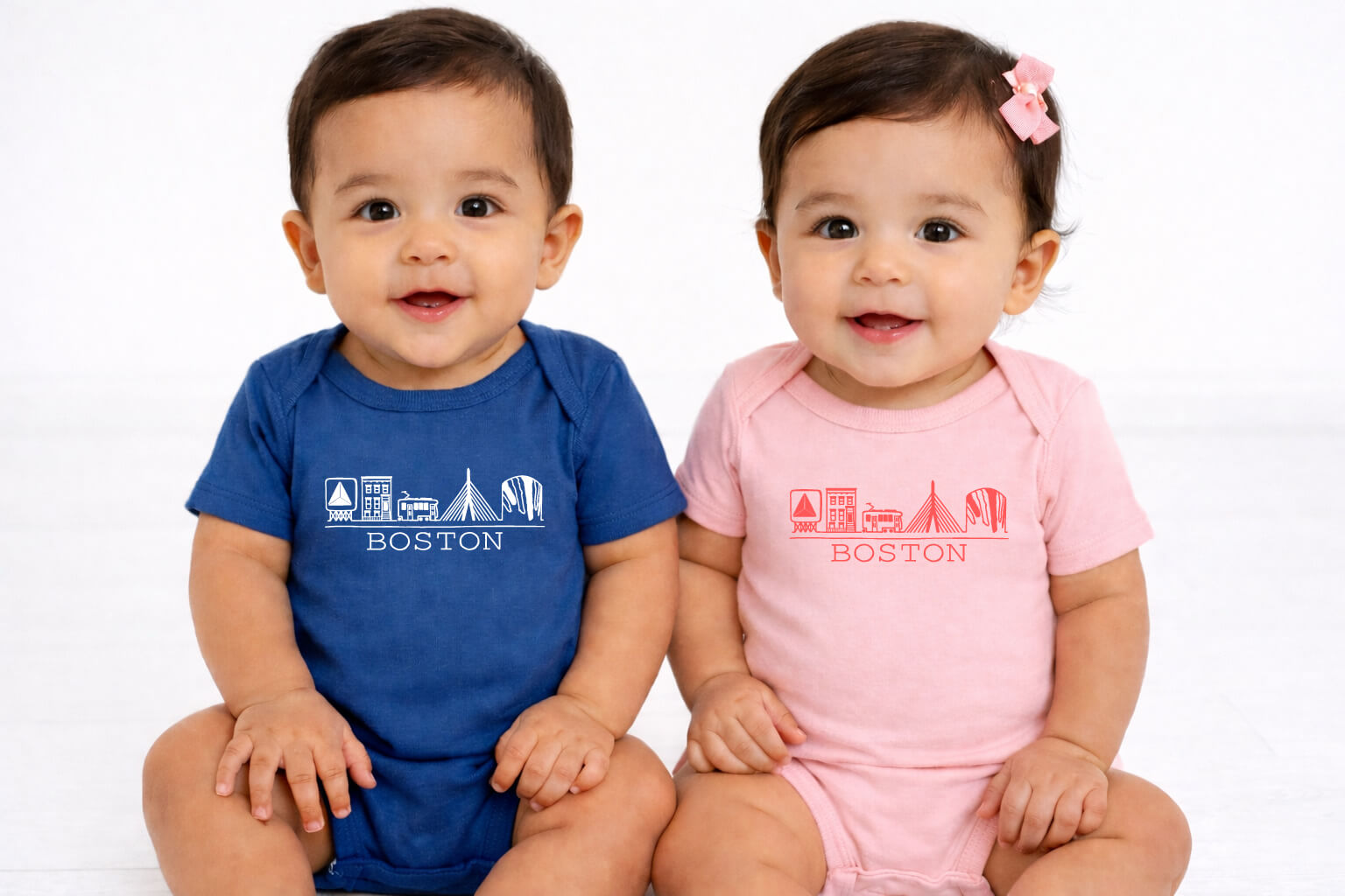 Boy and girl twins wearing cute Boston hand drawn Citgo Sign brownstone trolley zakim gas tank graphic onesies - blue and pink