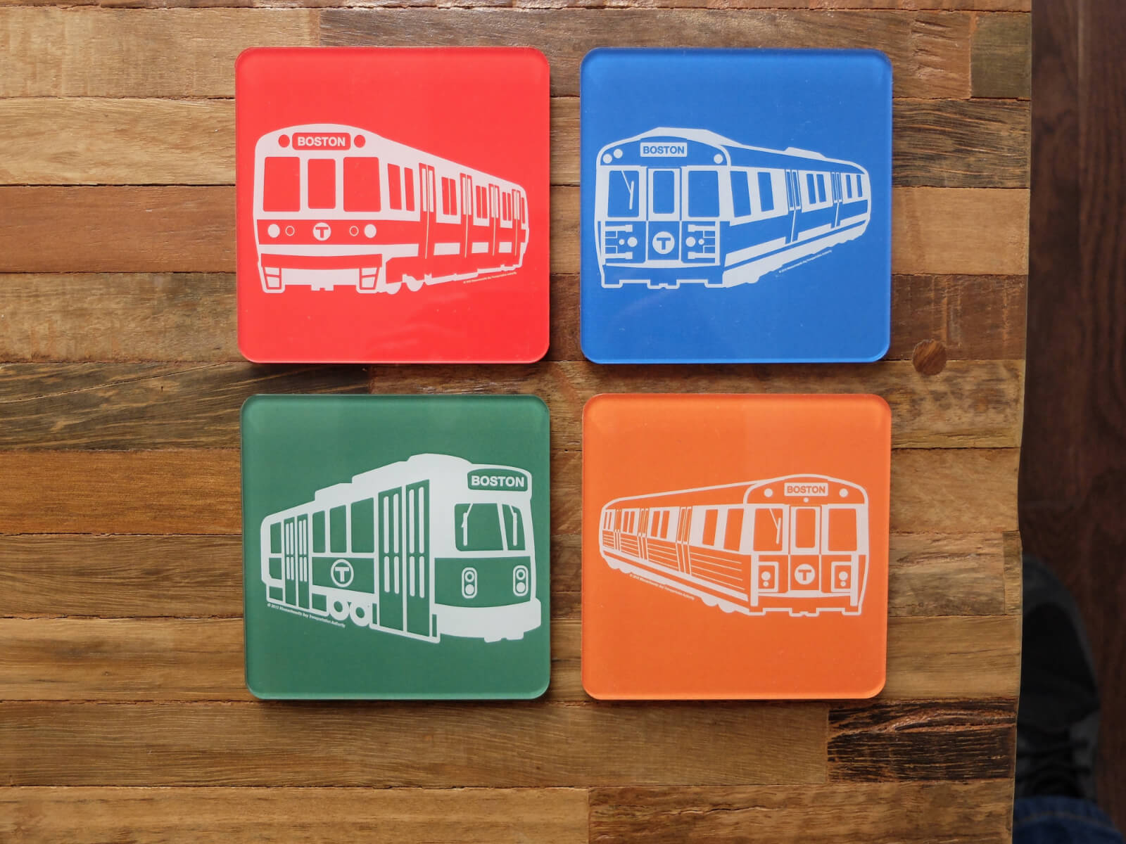 Set of four colorful acrylic and cork drink coasters representing each line of the Boston, Massachusetts subway
