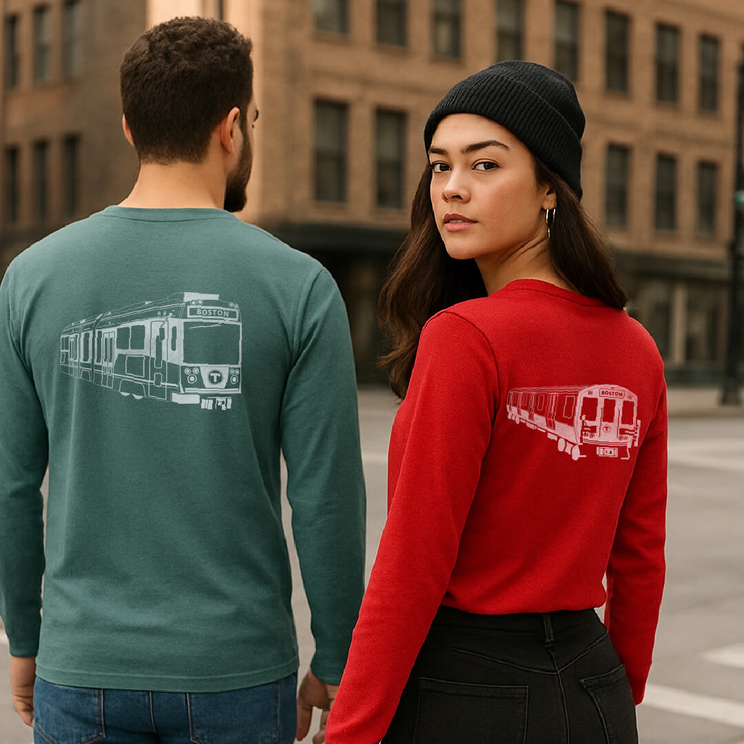 Man and woman walking in city wearing back side print MBTA red and green liine train graphic long sleeve cotton t-shirts.