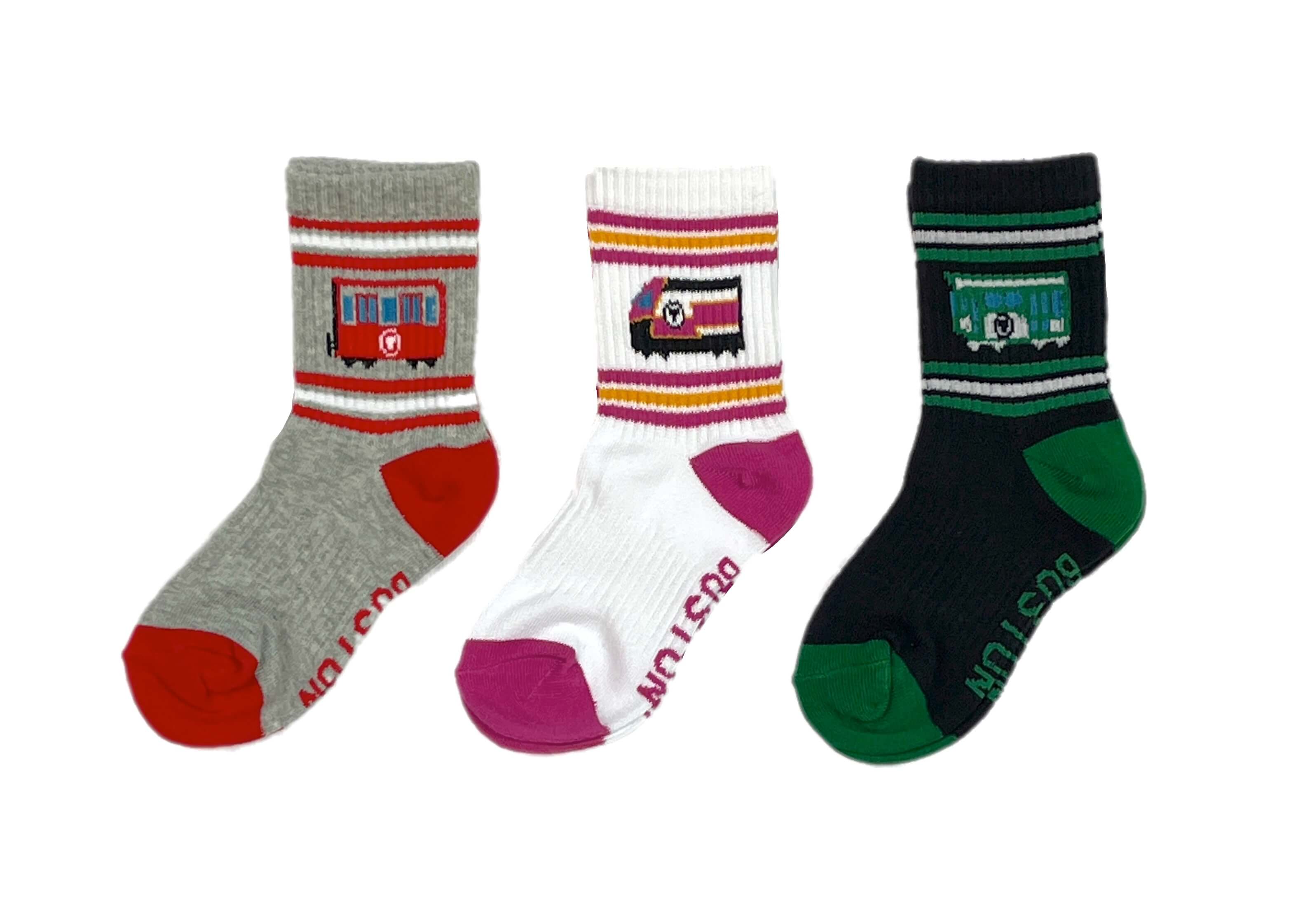 Three pairs of toddler size cotton crew socks with MBTA trains horizontal stripes and Boston text
