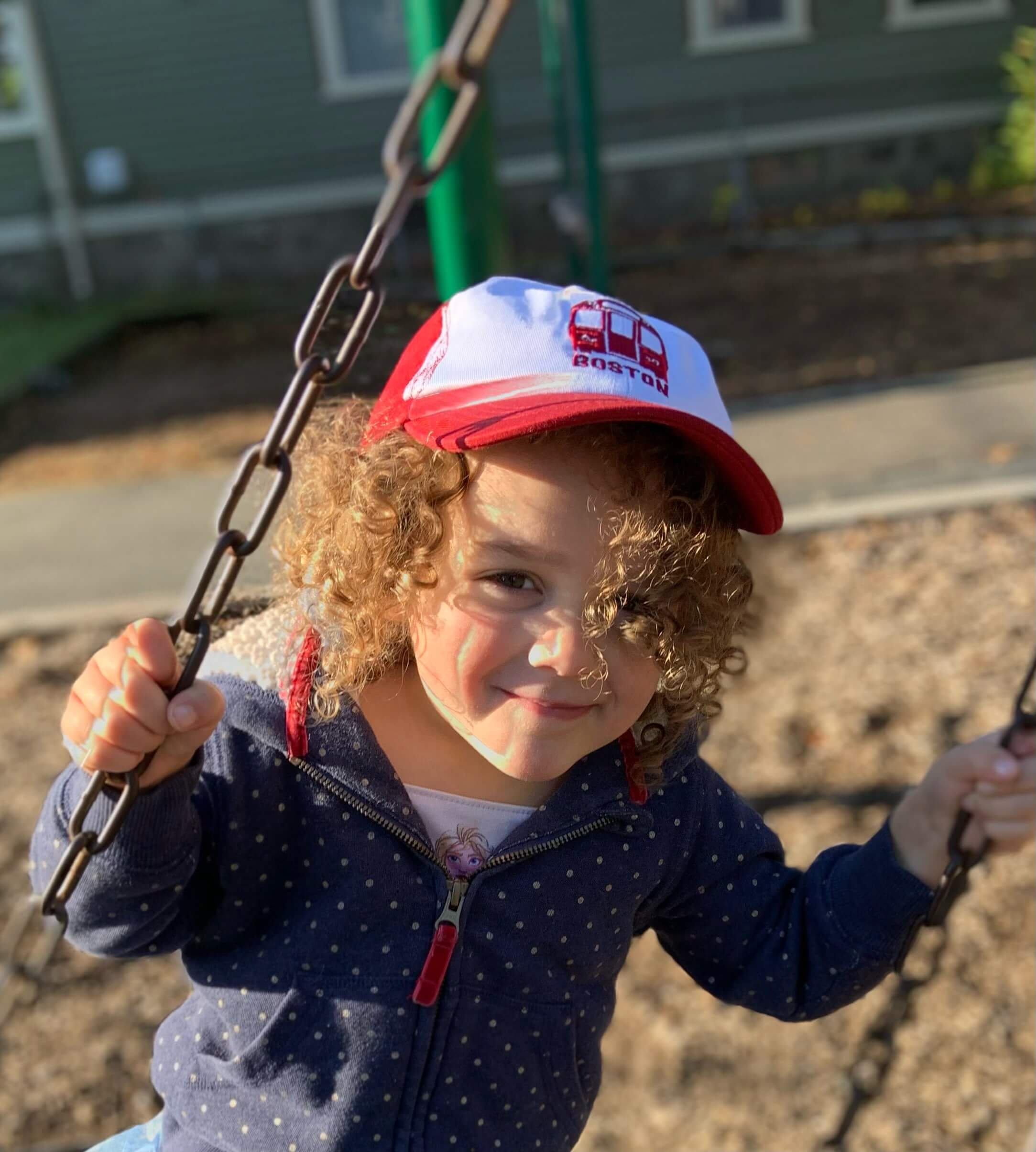 girl wearing mbta boston red line train red and white baseball cap